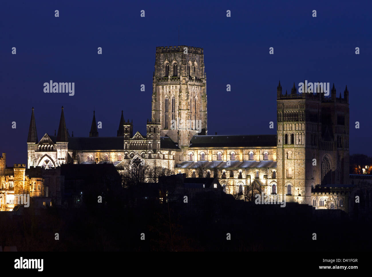 A view of Durham Cathedral floodlit at night as seen from an elevated position at Durham Railway Station Stock Photo