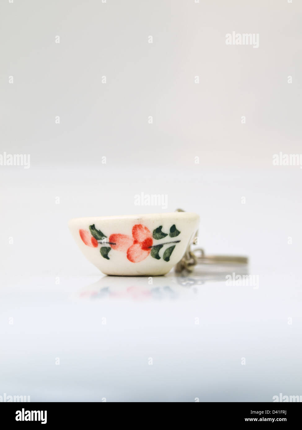 A miniature ceramic bowl key-chain, handicraft from Lampang, North of Thailand Stock Photo