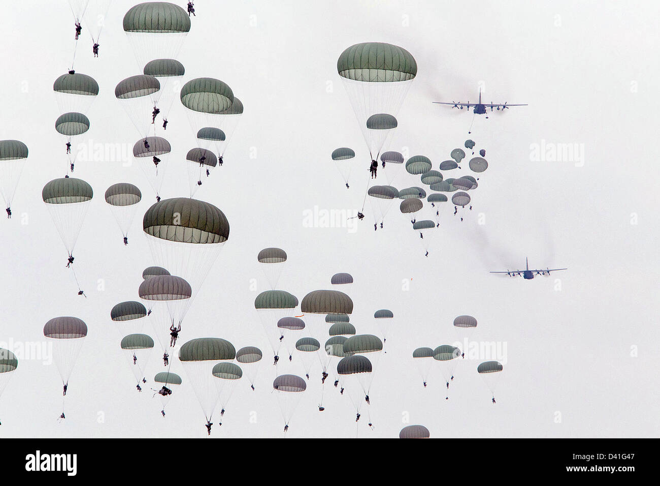 US Army 82nd Airborne Division soldiers parachute jump from Air Force C-130 Hercules aircraft during training February 25, 2013 at Fort Bragg, NC. Stock Photo