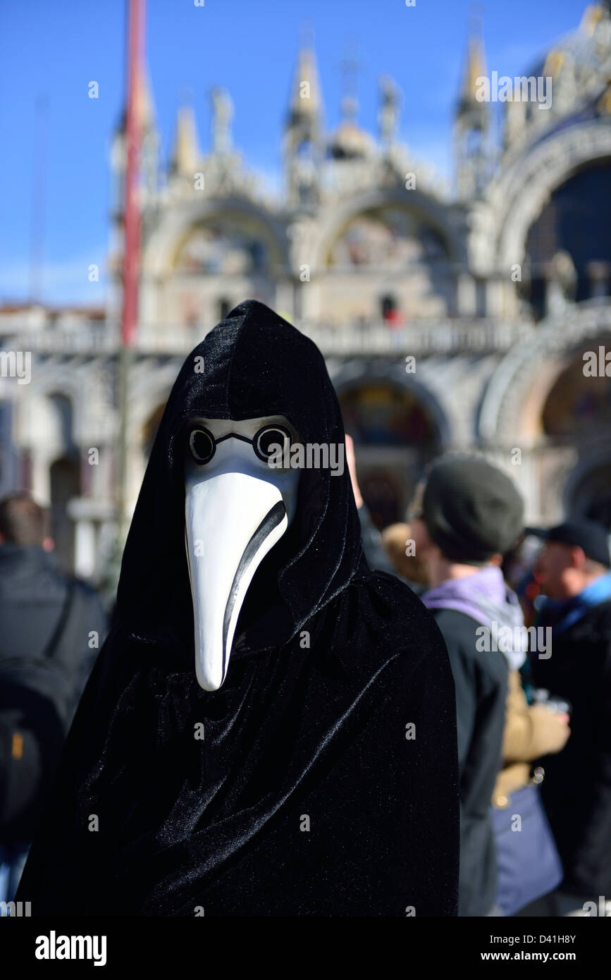 The plague doctor mask in front of St.Mark's cathedral at 2013 Venice carnival; Venice, Veneto. Italy. Stock Photo