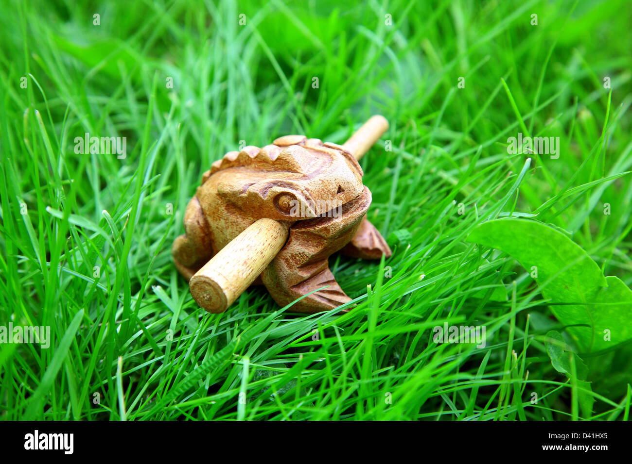 Asian handmade wealthy frog on green grass background Stock Photo