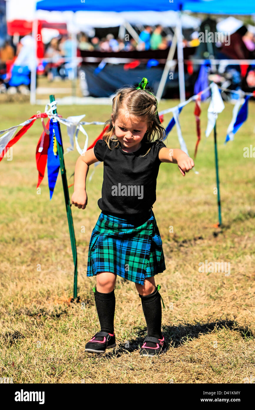 Small female child wearing a kilt at the Sarasota Highland Games Florida, Stock Photo