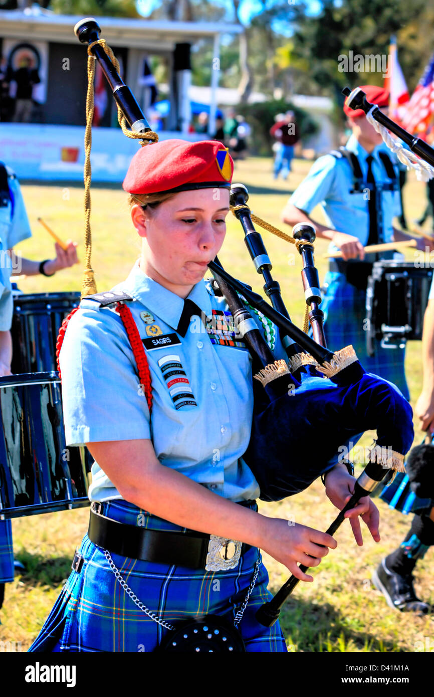 AmericanScottish teenage female bagpipe Band march around the arena at