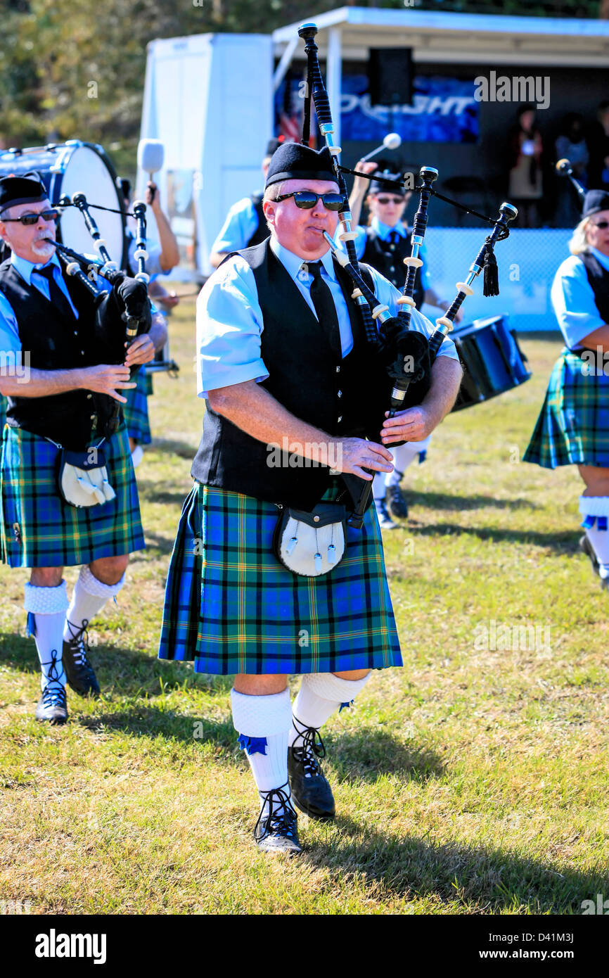 American-Scottish bagpipe Bandsmen & women march around the arena at the Sarasota Highland Games. Stock Photo