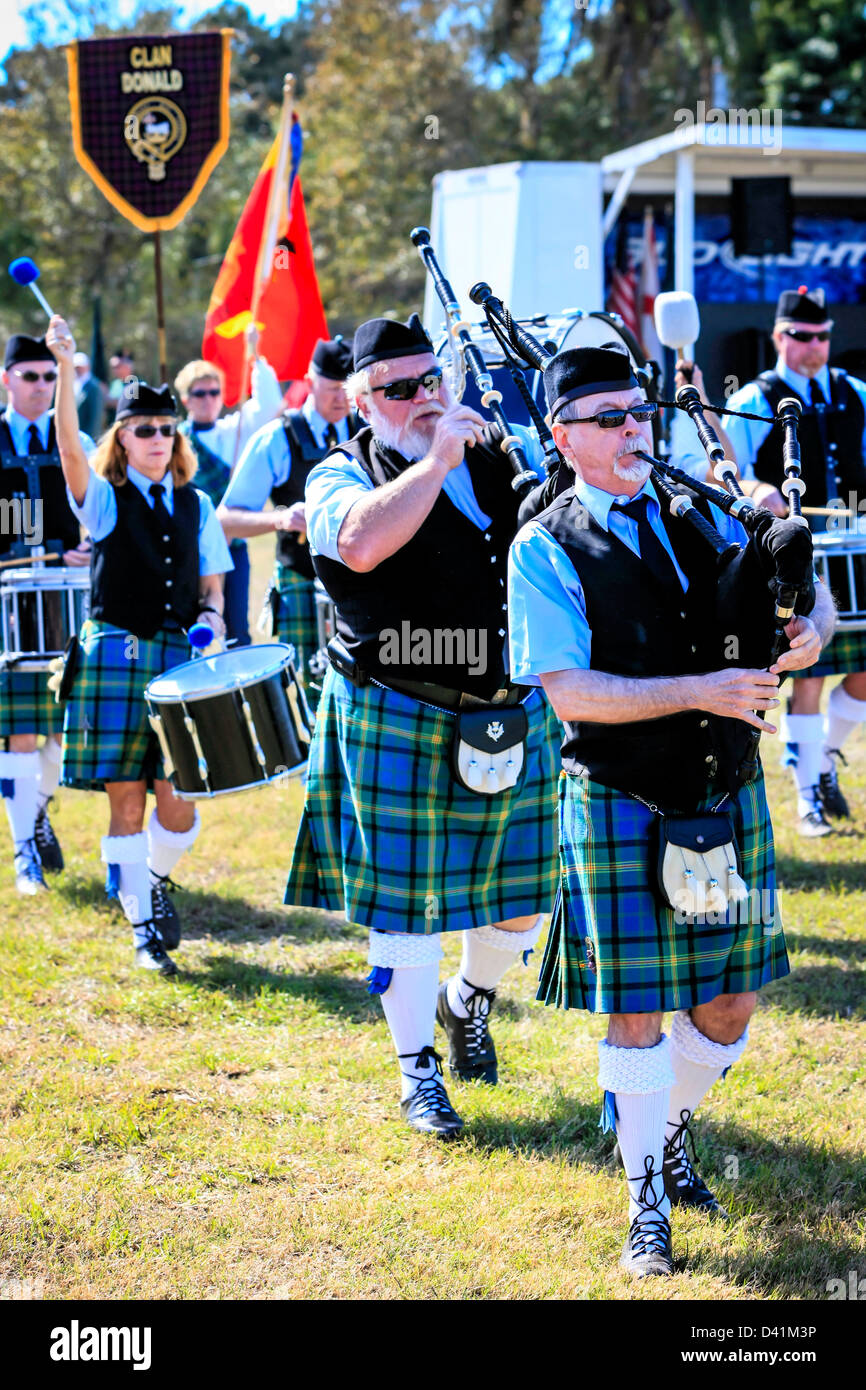 American-Scottish bagpipe Bandsmen & women march around the arena at the Sarasota Highland Games. Stock Photo