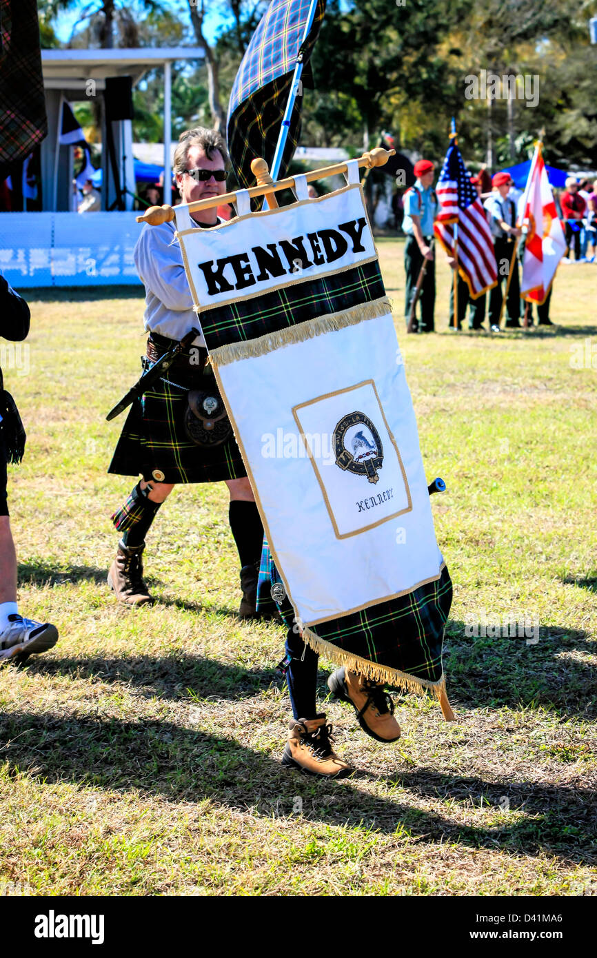 American-Scottish clan Kennedy men & women march around the arena at the Sarasota Highland Games. Stock Photo