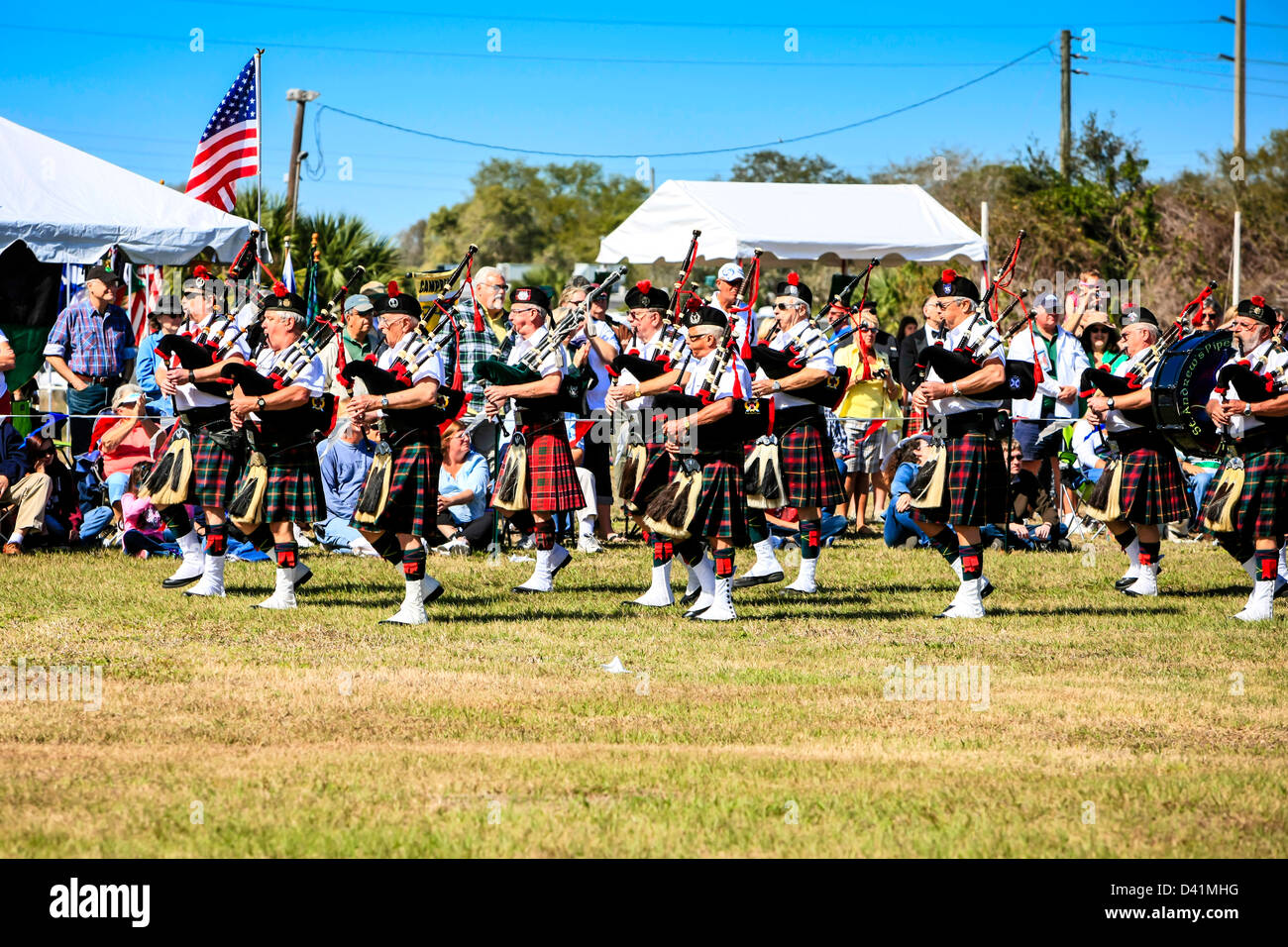 AmericanScottish Highland Pipe Bandsmen marches around the arena at