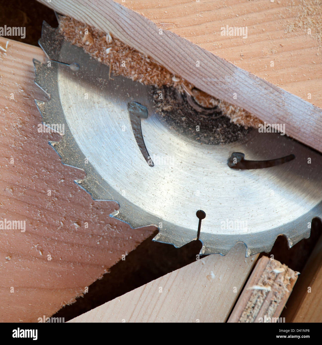 Close up of circular saw and saw dust with pieces of wood Stock Photo