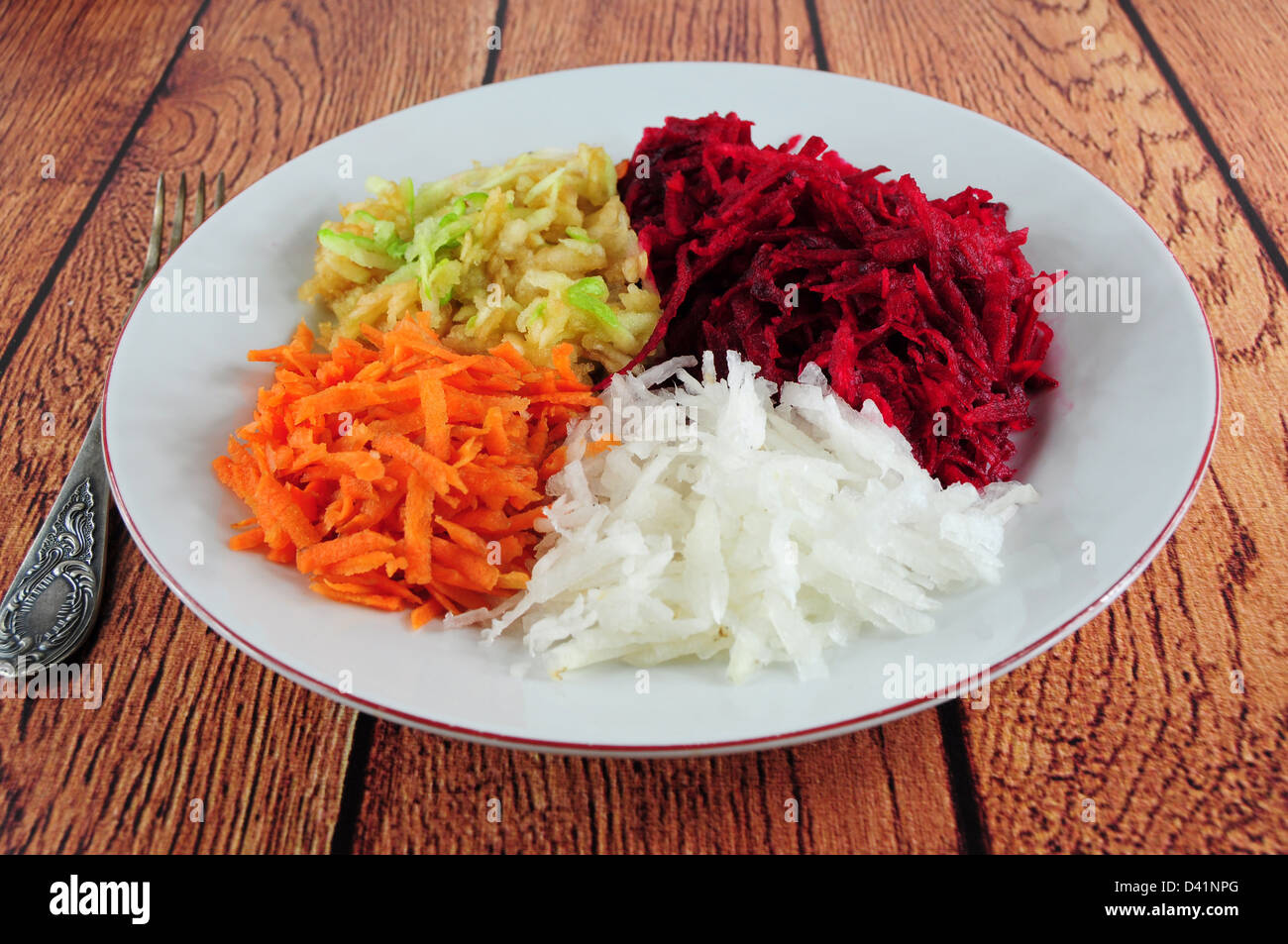 Salad from shredded beetroot, turnip, carrot and apple in a plate Stock