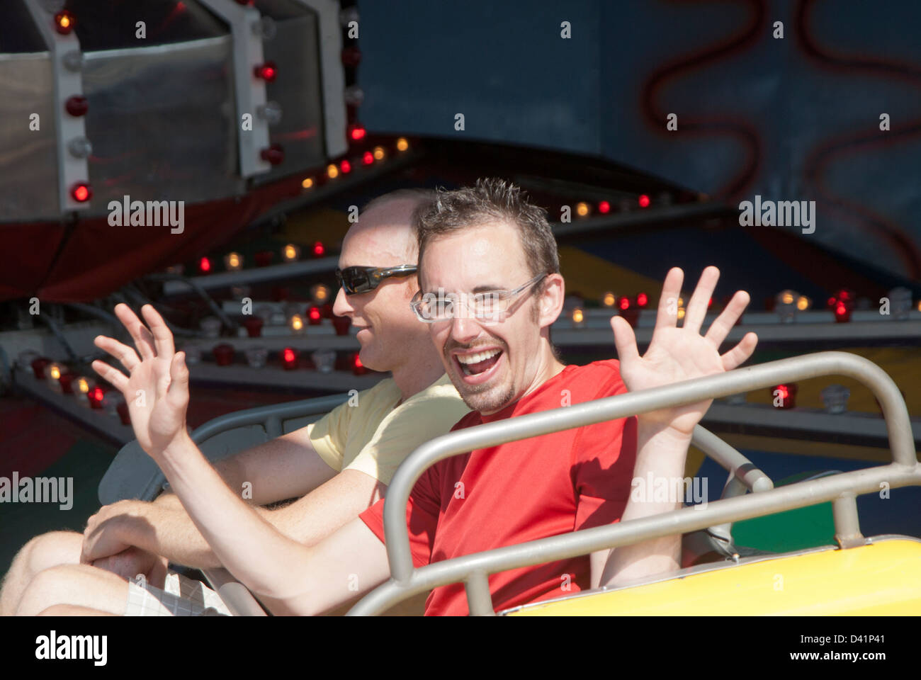 Two men on ride at an amusement park Stock Photo - Alamy