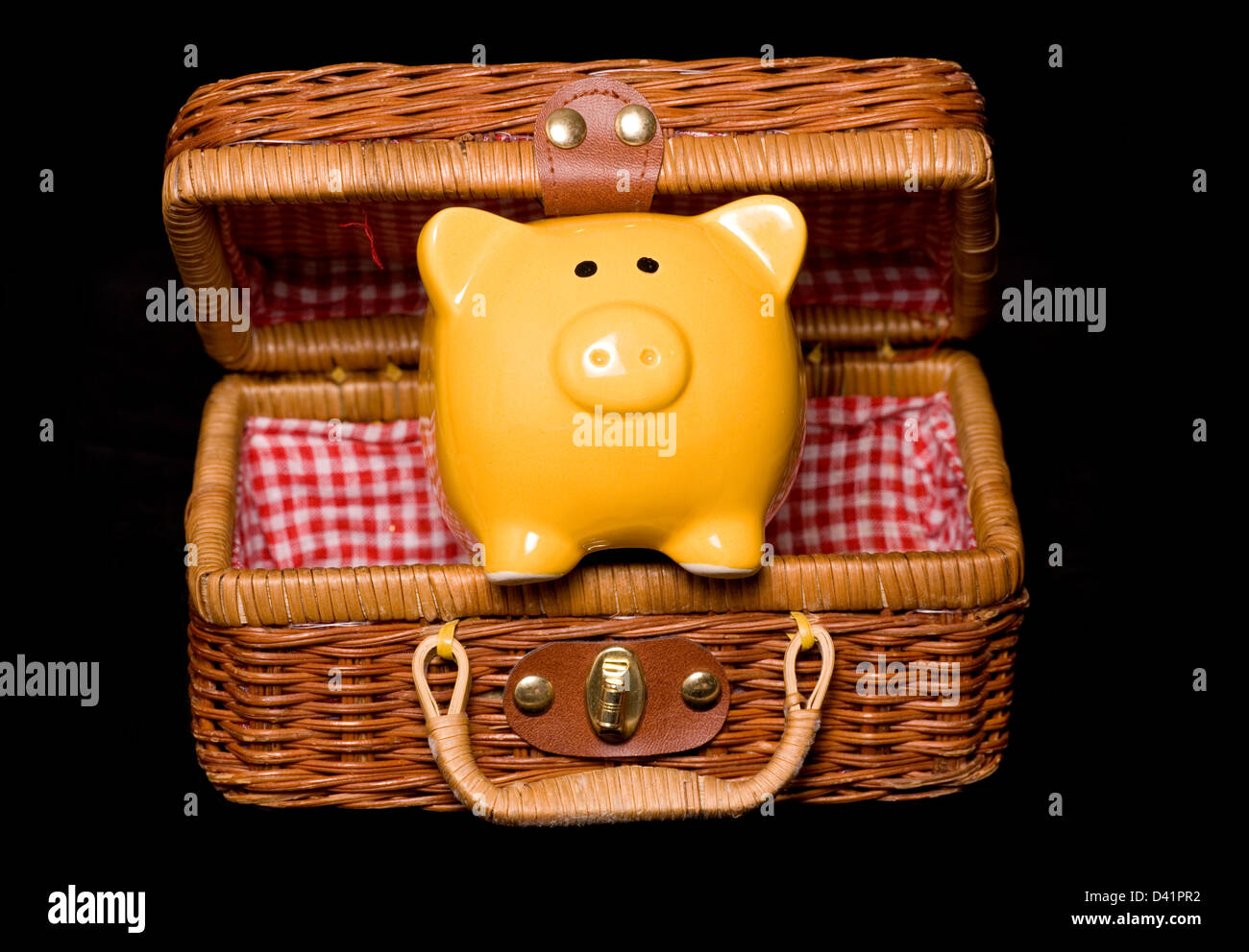 piggy bank in a wicker hamper cut out Stock Photo