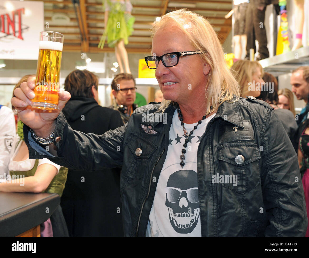 Robert Geiss, known from the television docusoap 'The Geissens', drinks a  beer at the trade fair area in Salzburg, Germany, 01 March 2013. His wife  Carmen Geissen will present her new collection '
