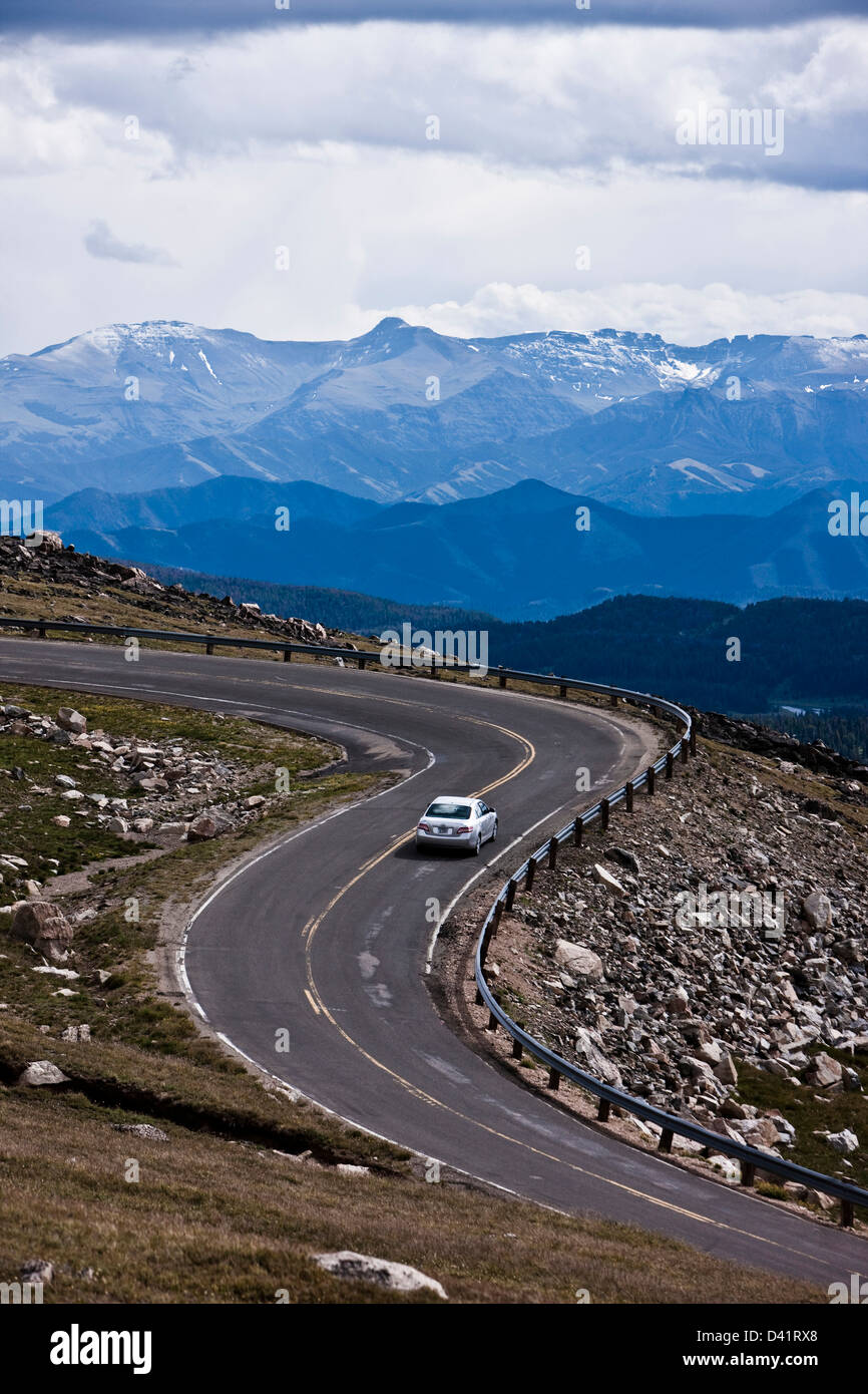 Car on road in Bear Tooth Pass in Yellowstone National Park Stock Photo