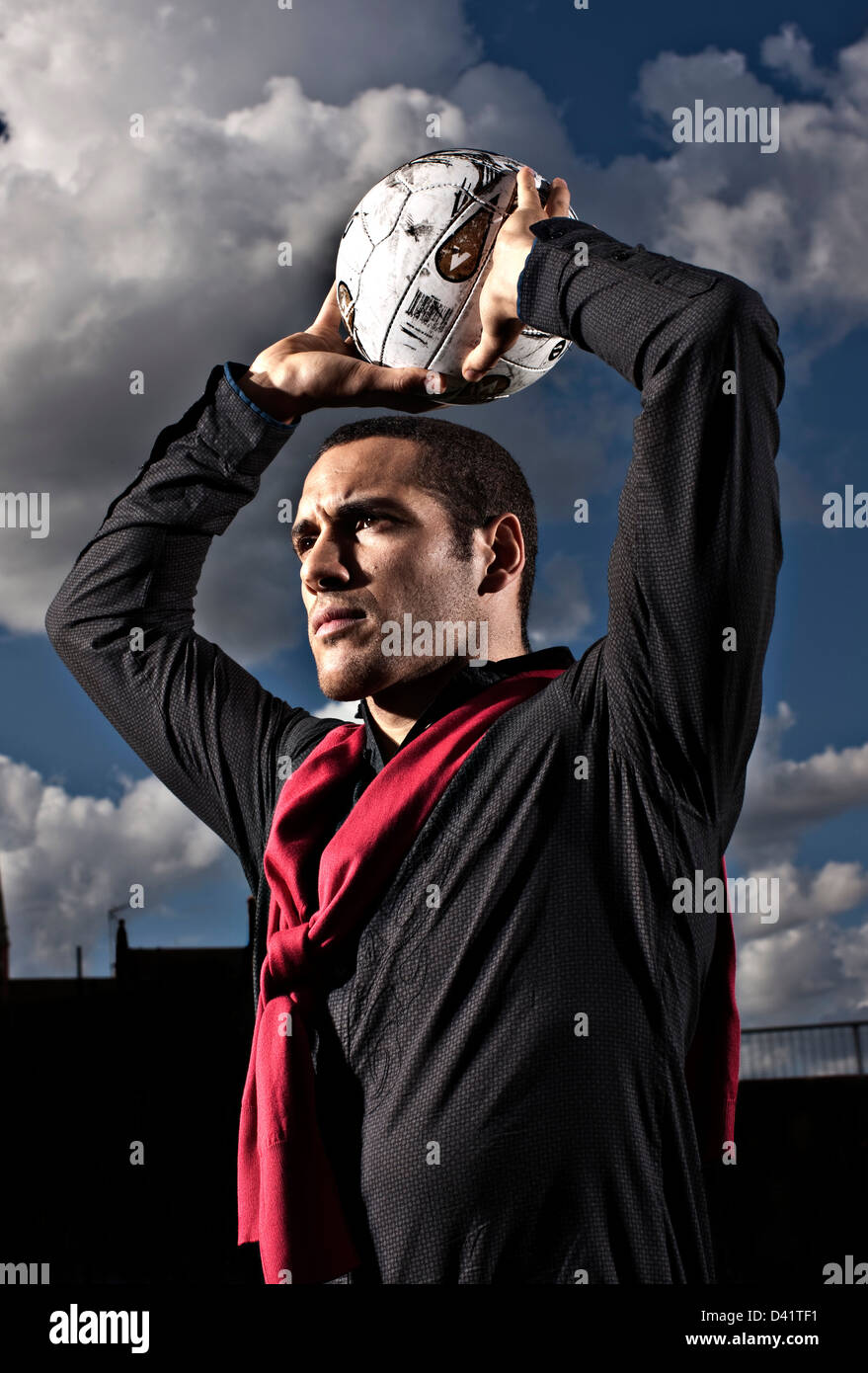 Footballer throwing ball in Stock Photo