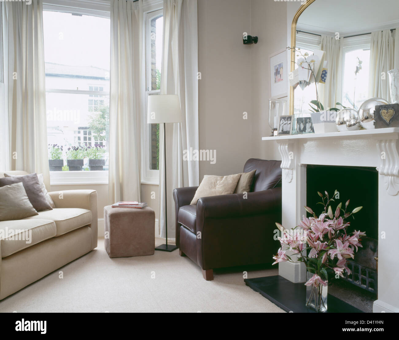 Brown leather armchair beside fireplace in townhouse living room with