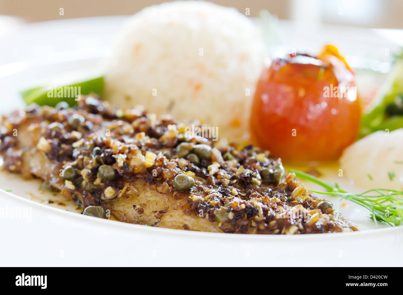 Fish Steak Rice fish steak served with fried rice and vegetable on white dish Stock ...