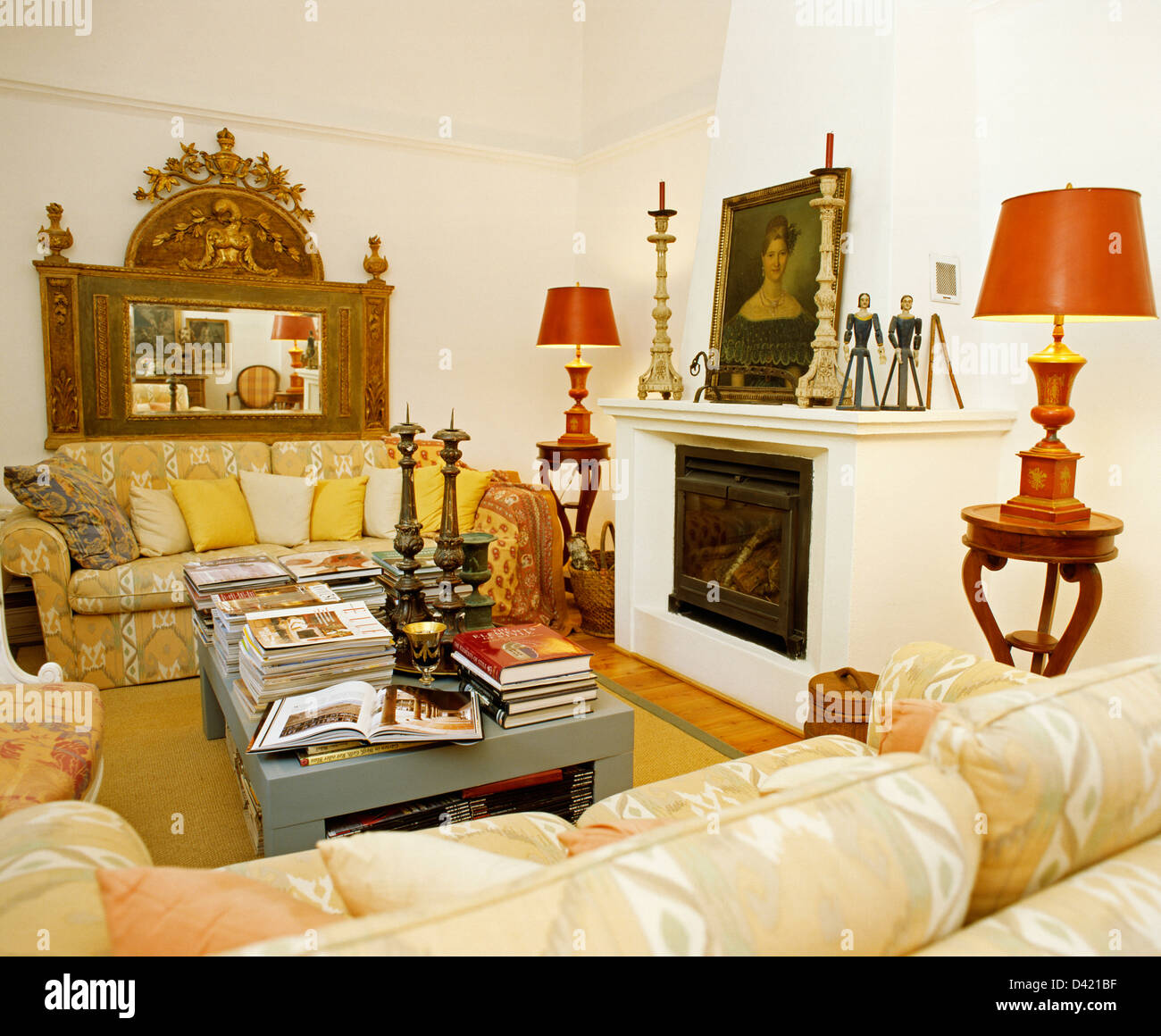 Red lamps on side tables beside fireplace in Portuguese living room
