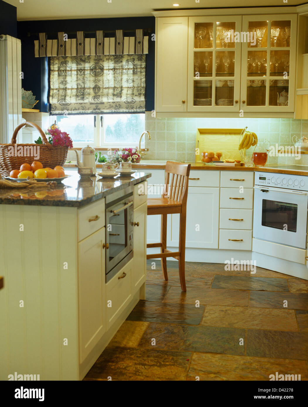 Island Unit And Slate Flooring In Country Kitchen With Patterned Blind On Window Beside Wall Cupboard Interior Lighting Island Unit And Slate Flooring In Country Kitchen With Patterned Blind On Window Beside Wall Cupboard Interior Lighting