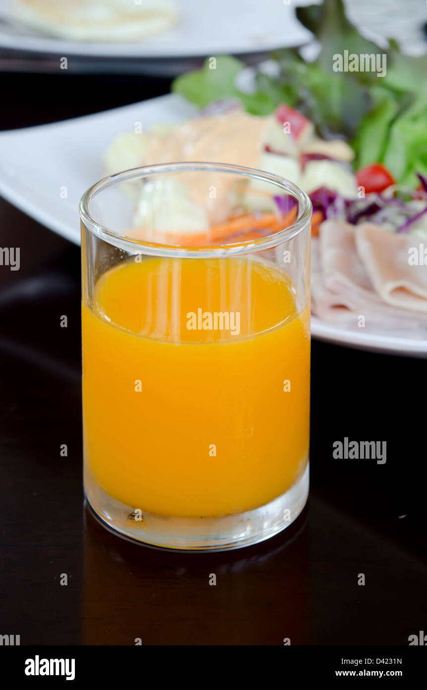 glass of orange juice and fresh salad Stock Photo