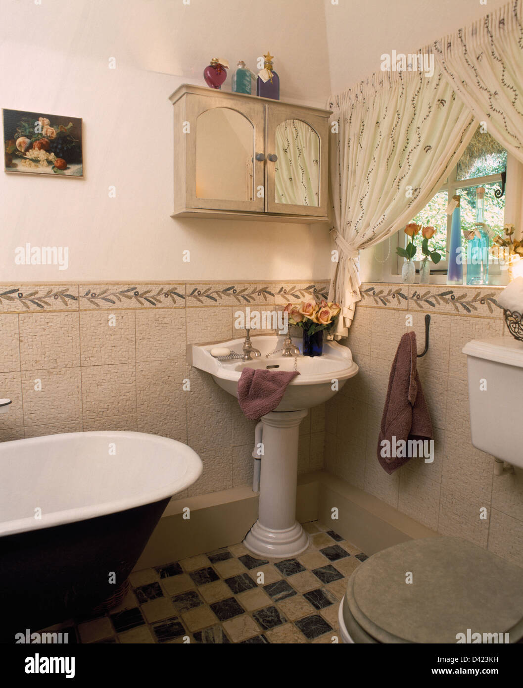 Small wallcupboard above pedestal basin in cottage bathroom with