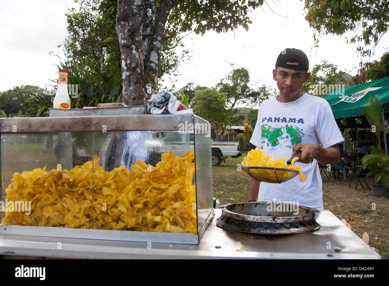 Vendor selling fried plantain chips at a folklore festival. Stock Photo