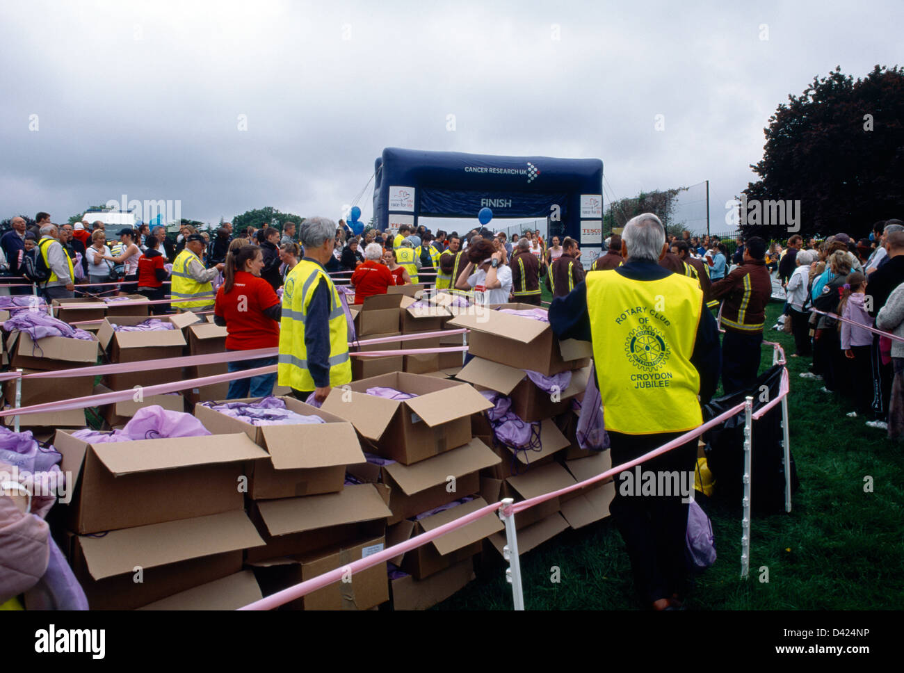 Rotary Club Giving Out Bags At The Finish Line Of Race For Life Raising Money For Cancer Research Stock Photo