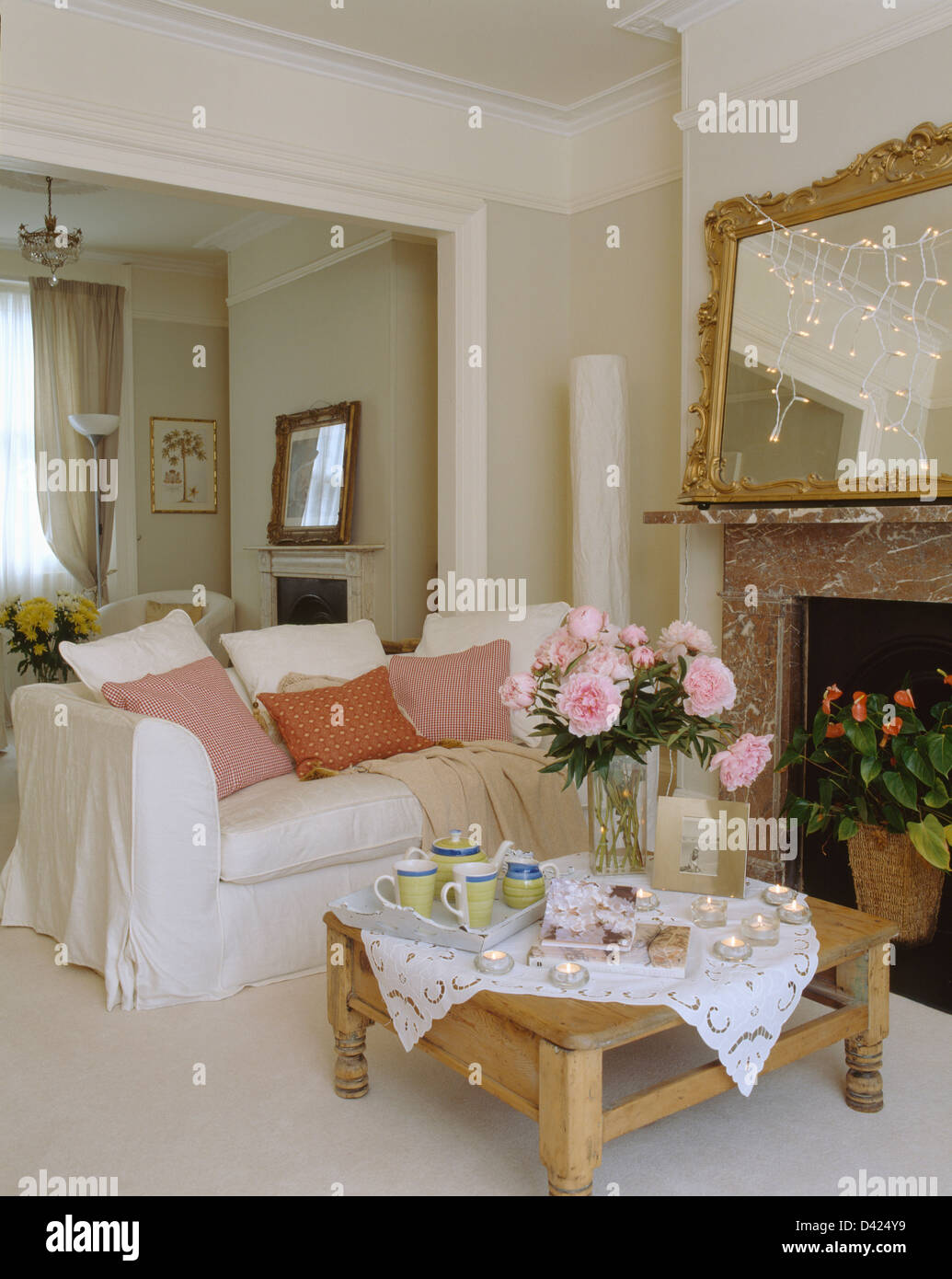 Candles And Pink Peonies With Tea Tray On Table In Front Of