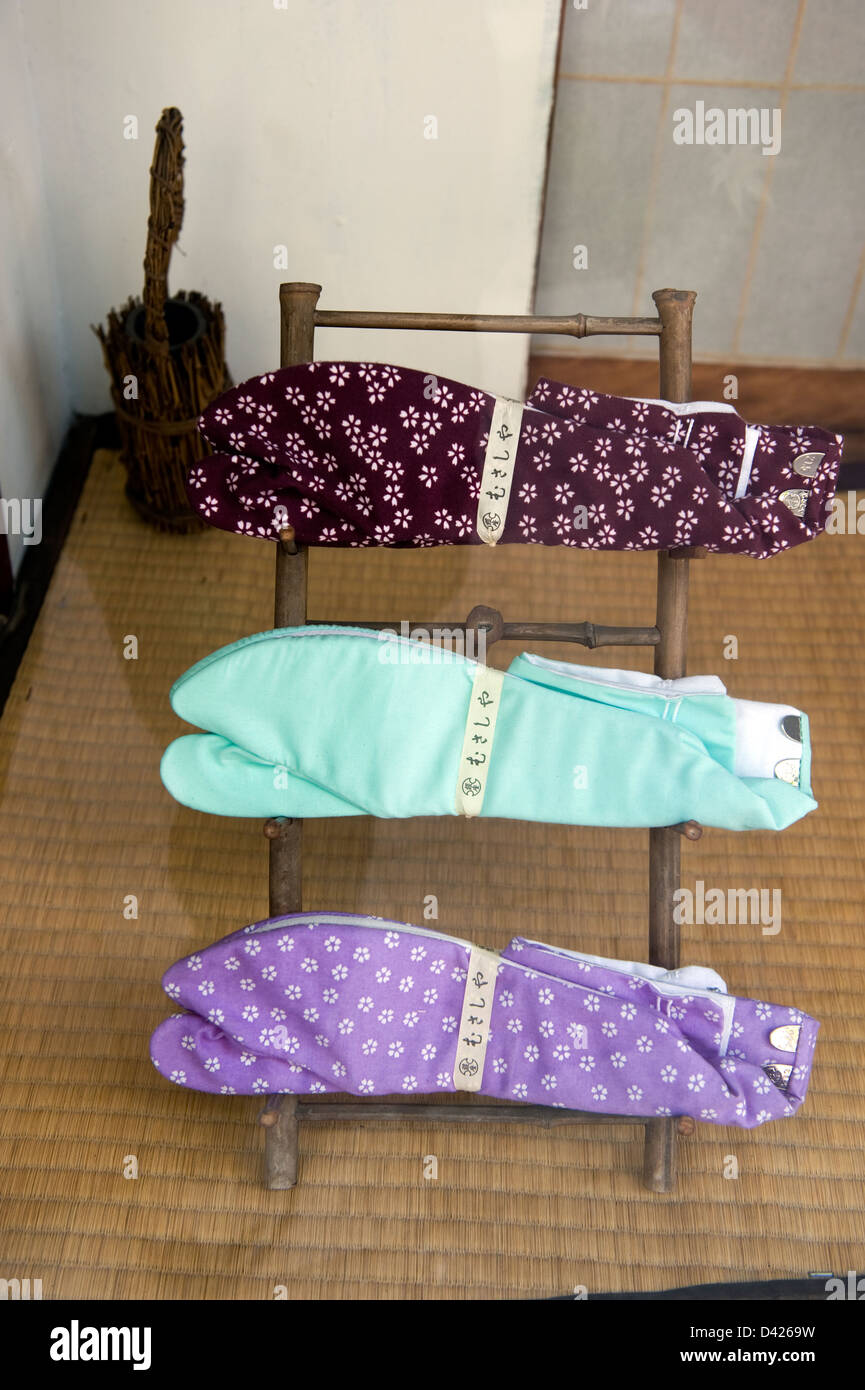 A shop window in Tokyo, Japan displaying traditional tabi two-toe socks in a variety of colors and patterns. Stock Photo