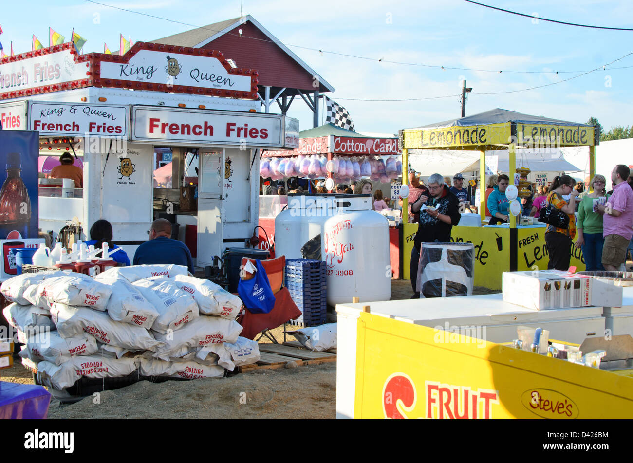 Behind the scenes at the fair - stacked bags of potatoes, propane tanks, gallons of ketchup, and other supplies. Stock Photo