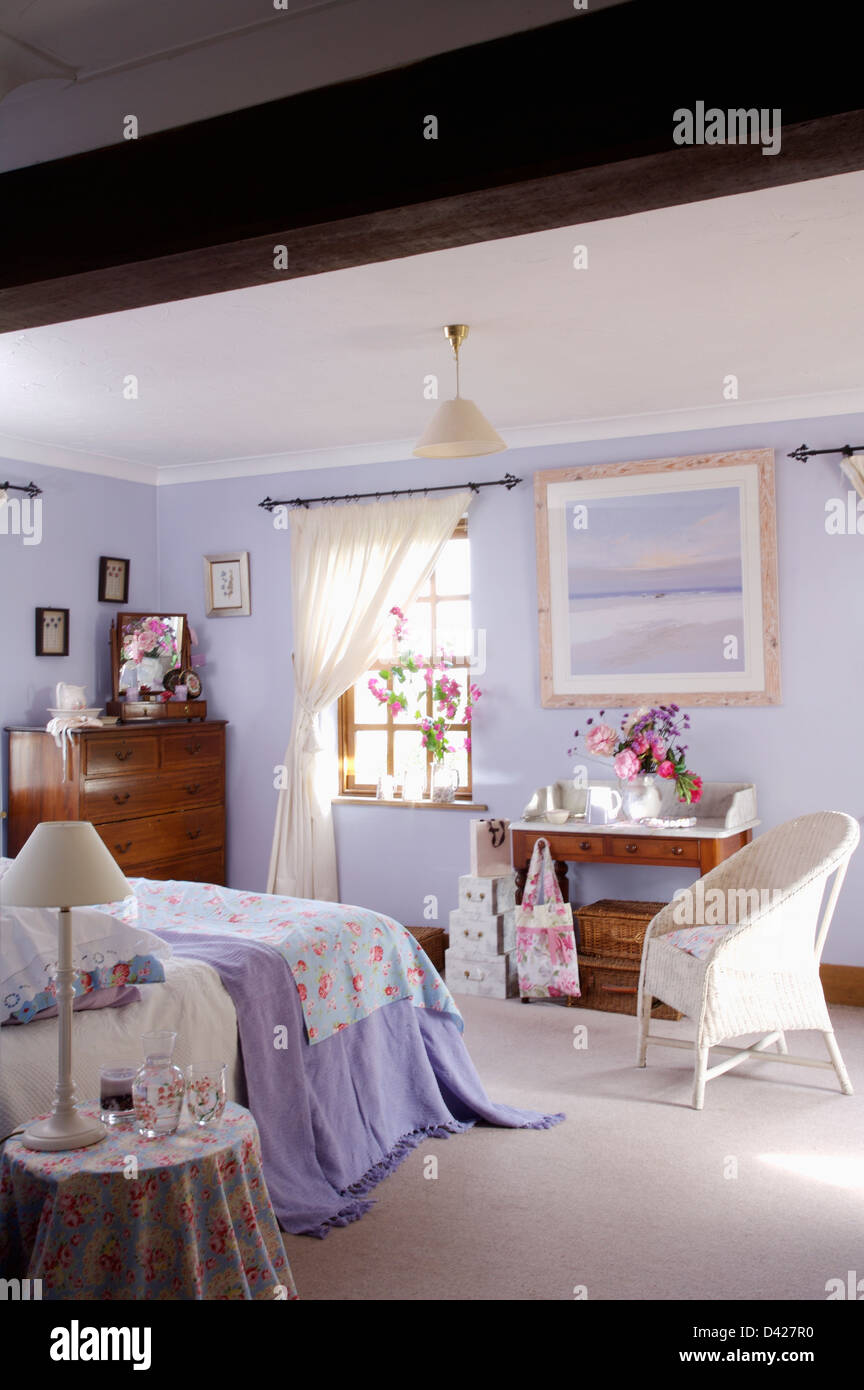 White "Lloyd Loom" chair in lilac bedroom with white carpet and lilac