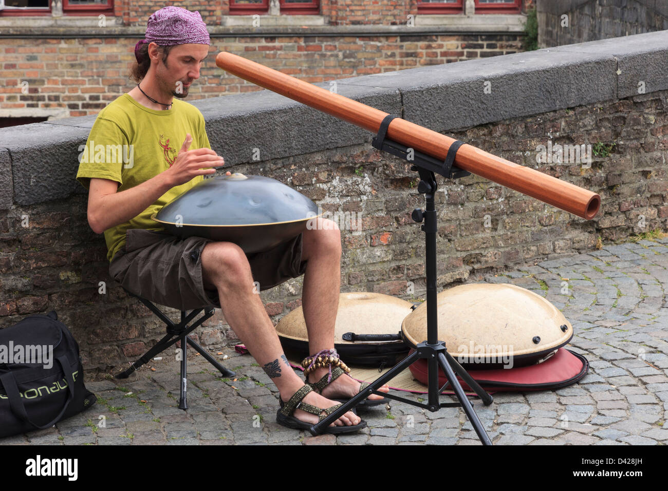 Street entertainer playing music in Bruges, East Flanders, Belgium, Europe. Stock Photo