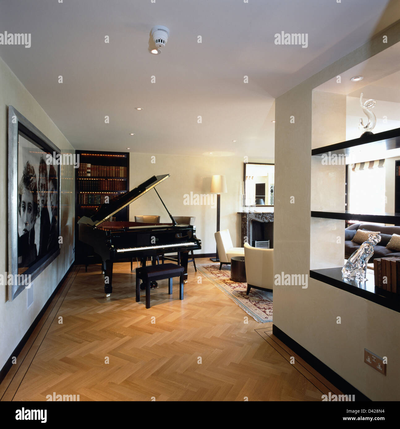 Grand piano in living room in modern city apartment with parquet floor and  open shelves on dividing wall Stock Photo - Alamy