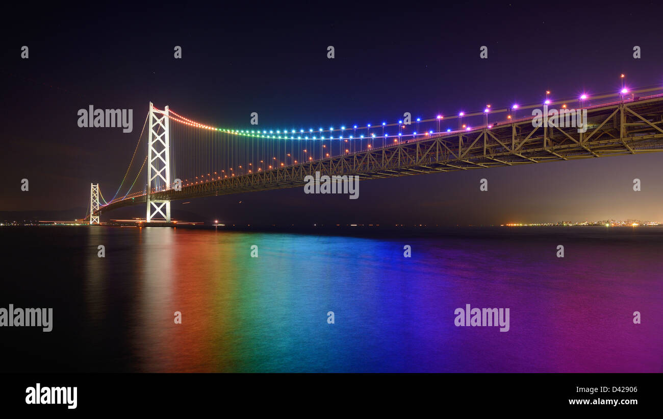 Rainbow lights on Akashi Ohashi (Pearl Bridge) in Kobe, Japan. Stock Photo