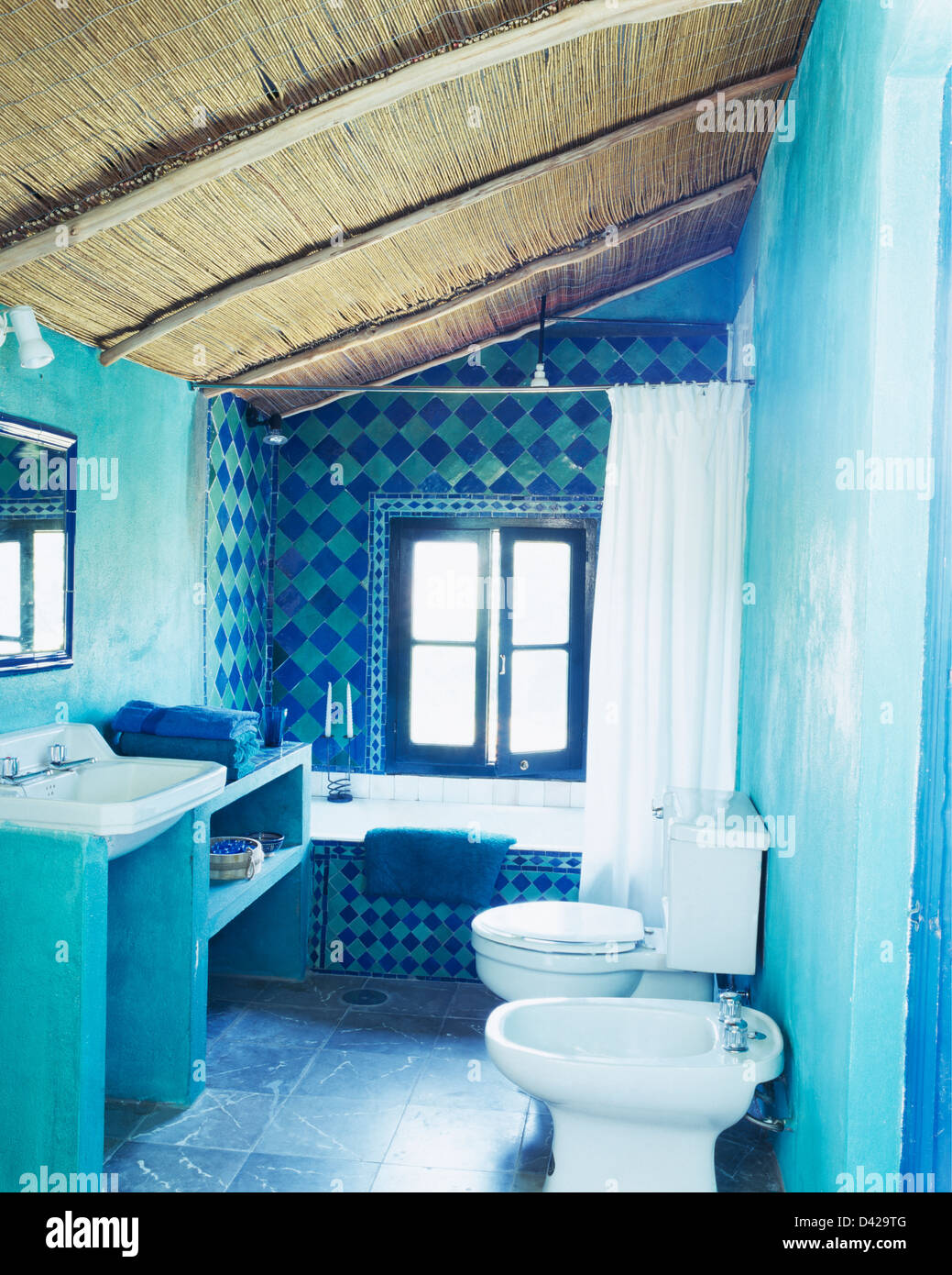 Thatched Ceiling In Turquoise Spanish Bathroom With