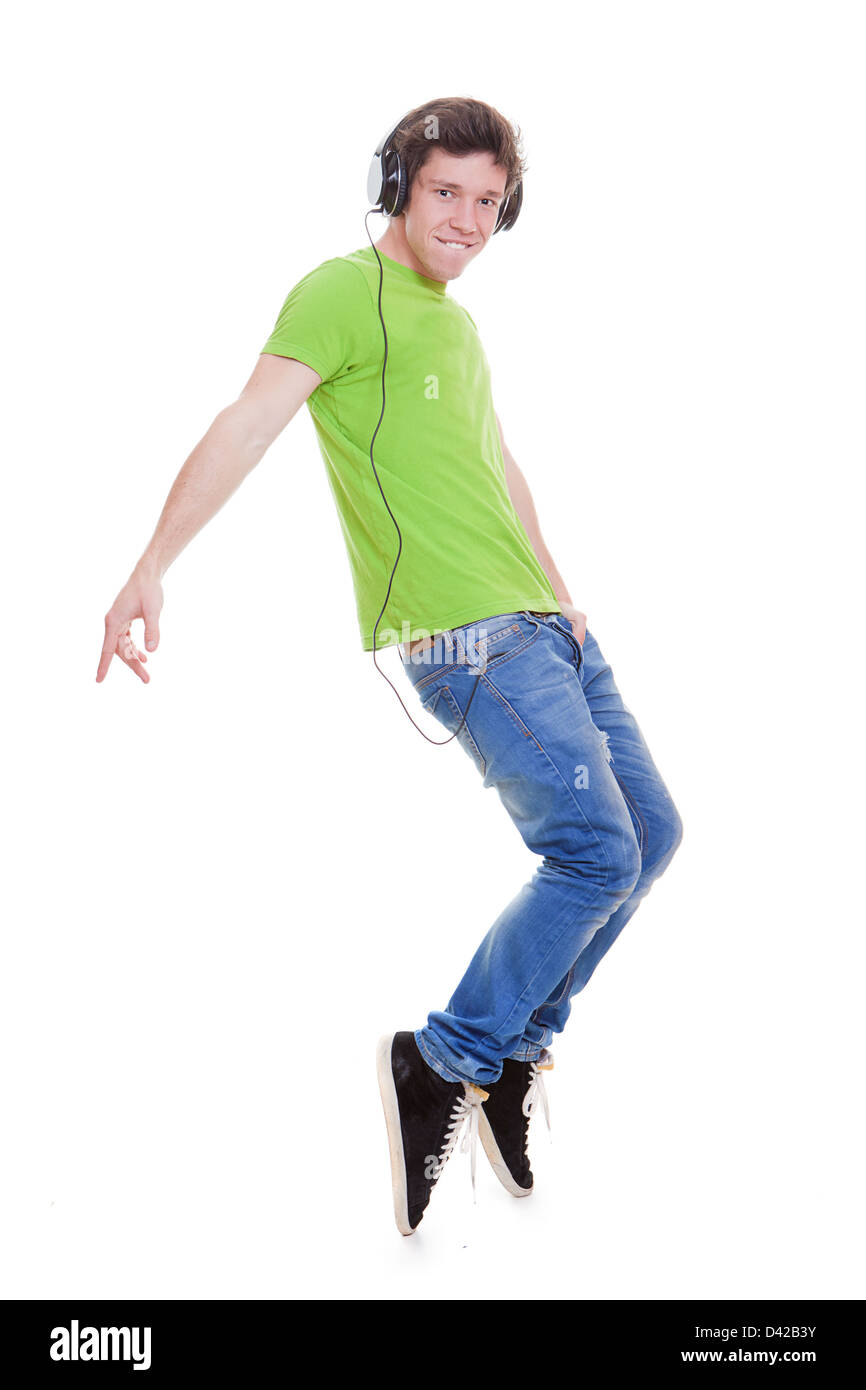 teen boy with headphones dancing to music Stock Photo
