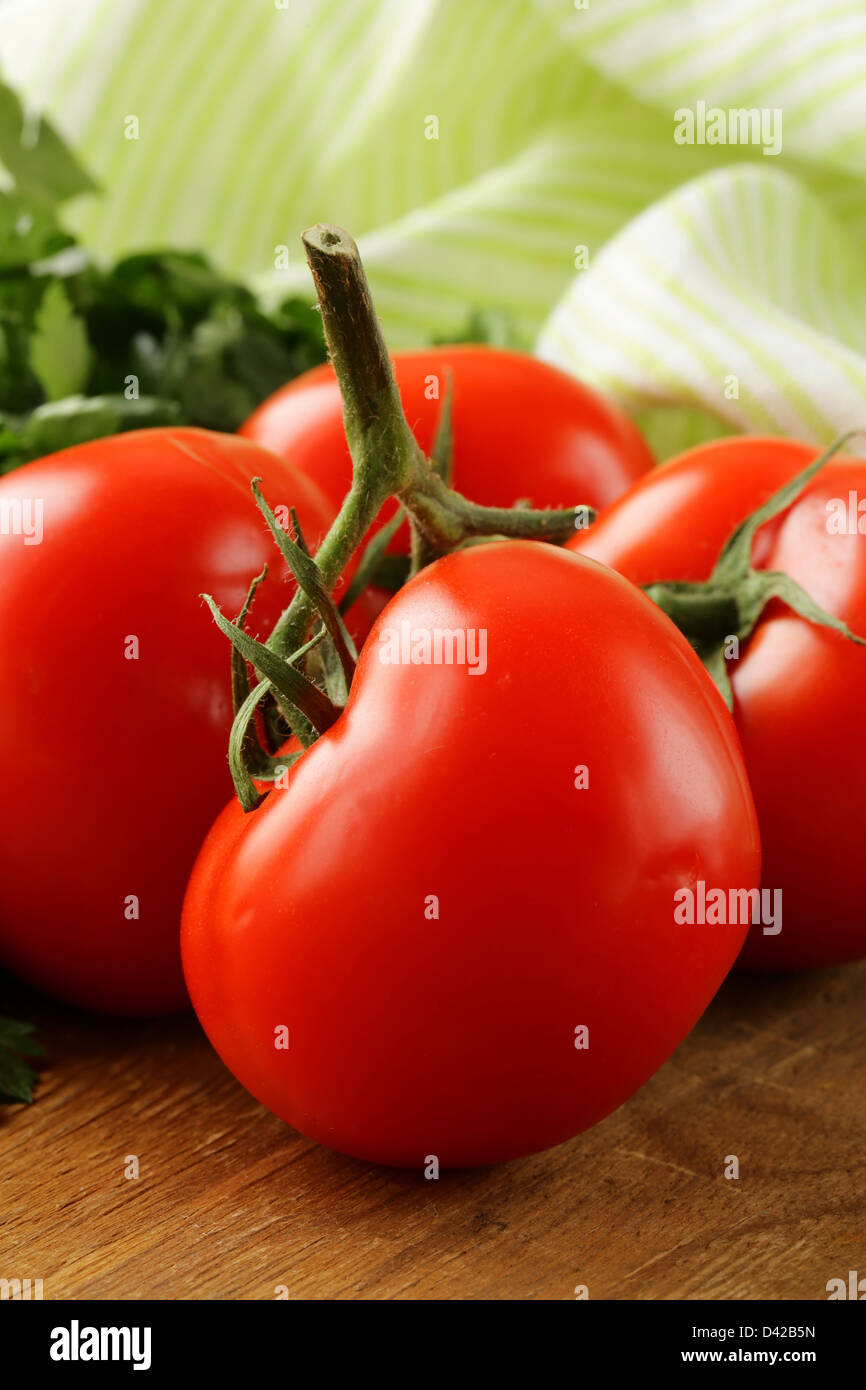 ripe organic tomatoes on a wooden table Stock Photo - Alamy