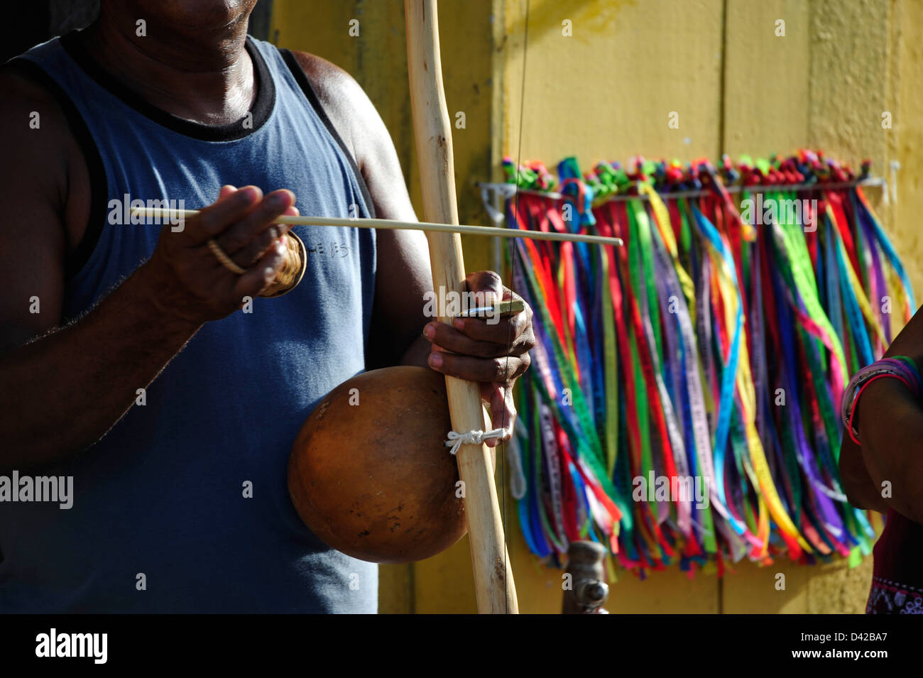 Man is playing the Berimbau, a typical instrument of Capoeira. Stock Photo