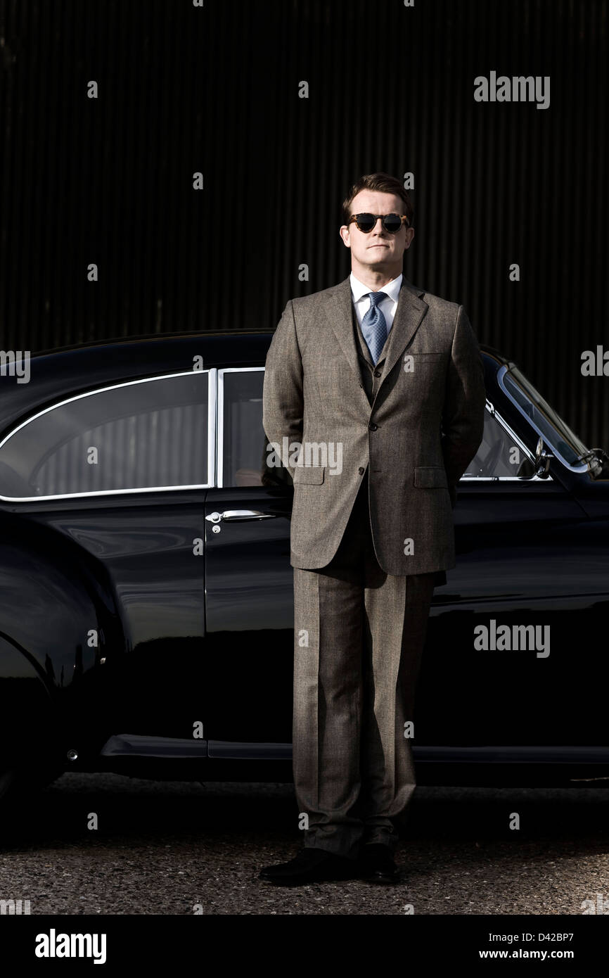 Chauffeur stands with Bentley R Type Continental car Stock Photo