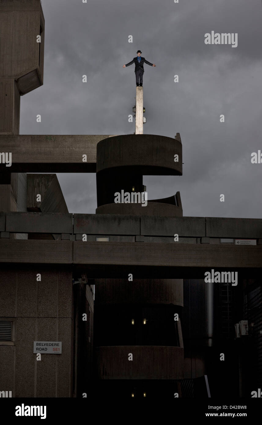 Parkour runner balancing on top of concrete building structure Stock Photo