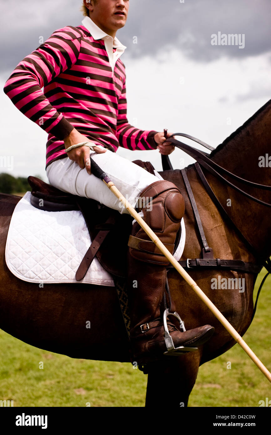 Polo player sitting on horseback with mallet Stock Photo