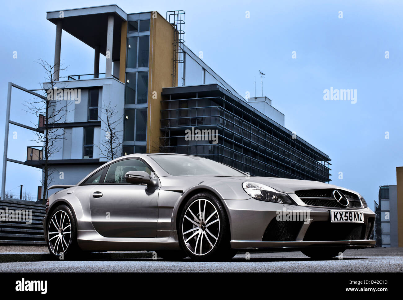 Silver Mercedes Benz SL 65 parked in urban environment Stock Photo