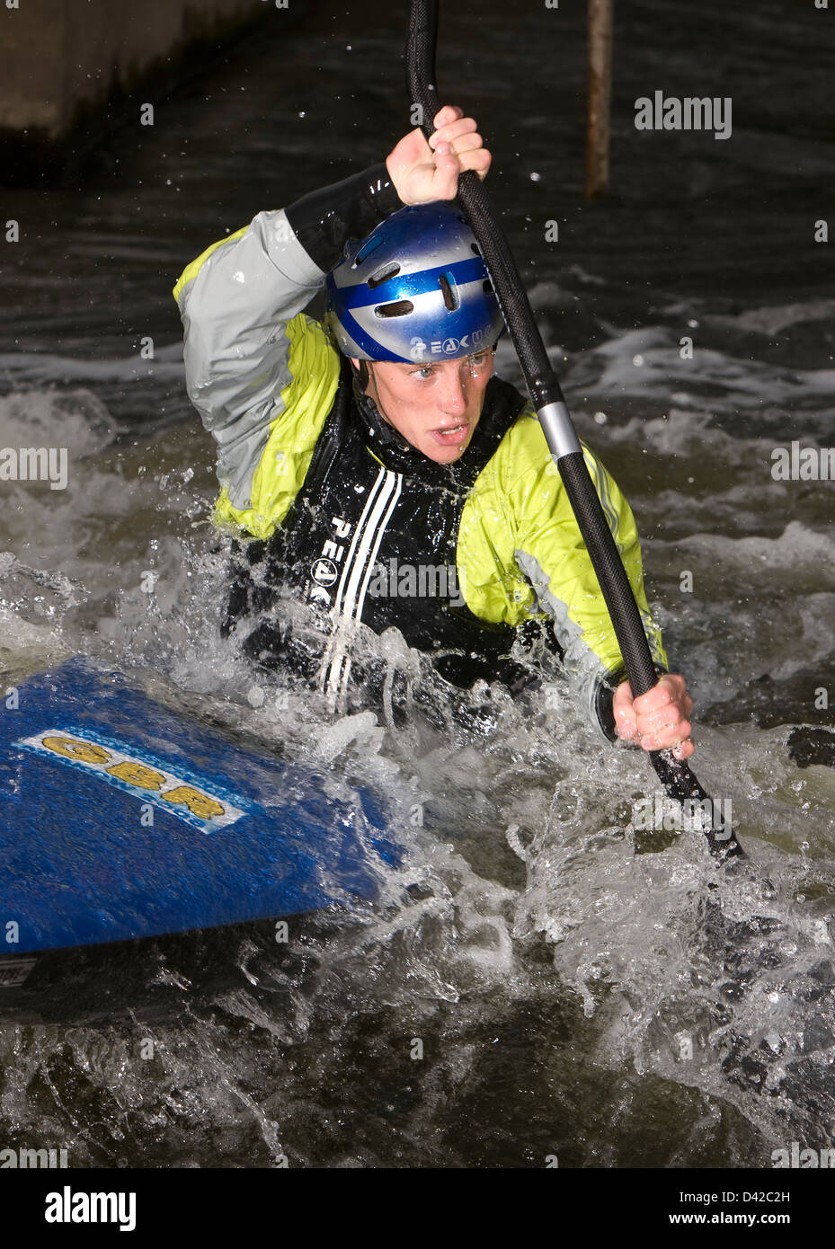 Man paddling a canoe in rapids with determination Stock Photo