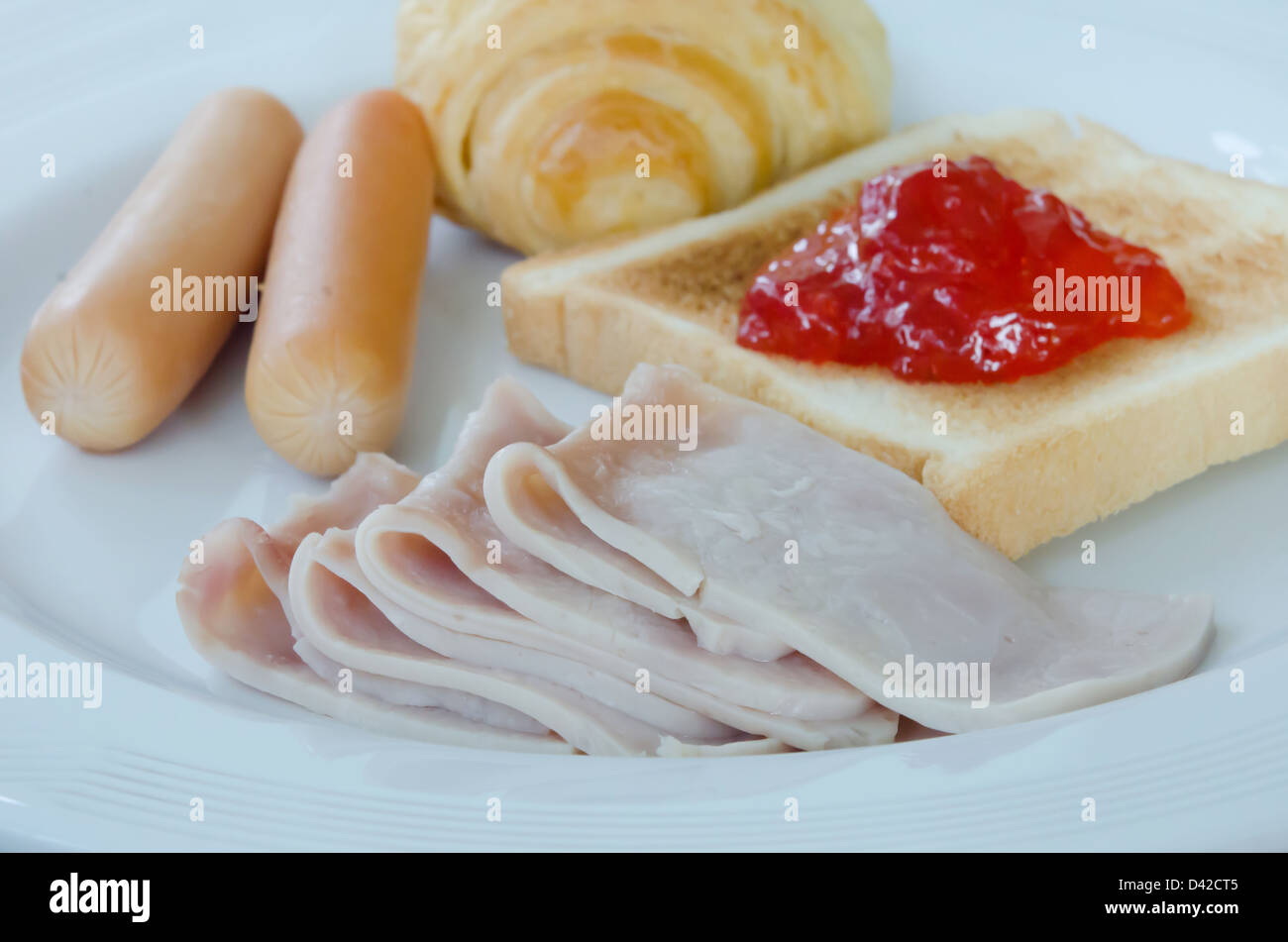 fresh breakfast , with bacon, bread , sausage , toast and jam Stock Photo