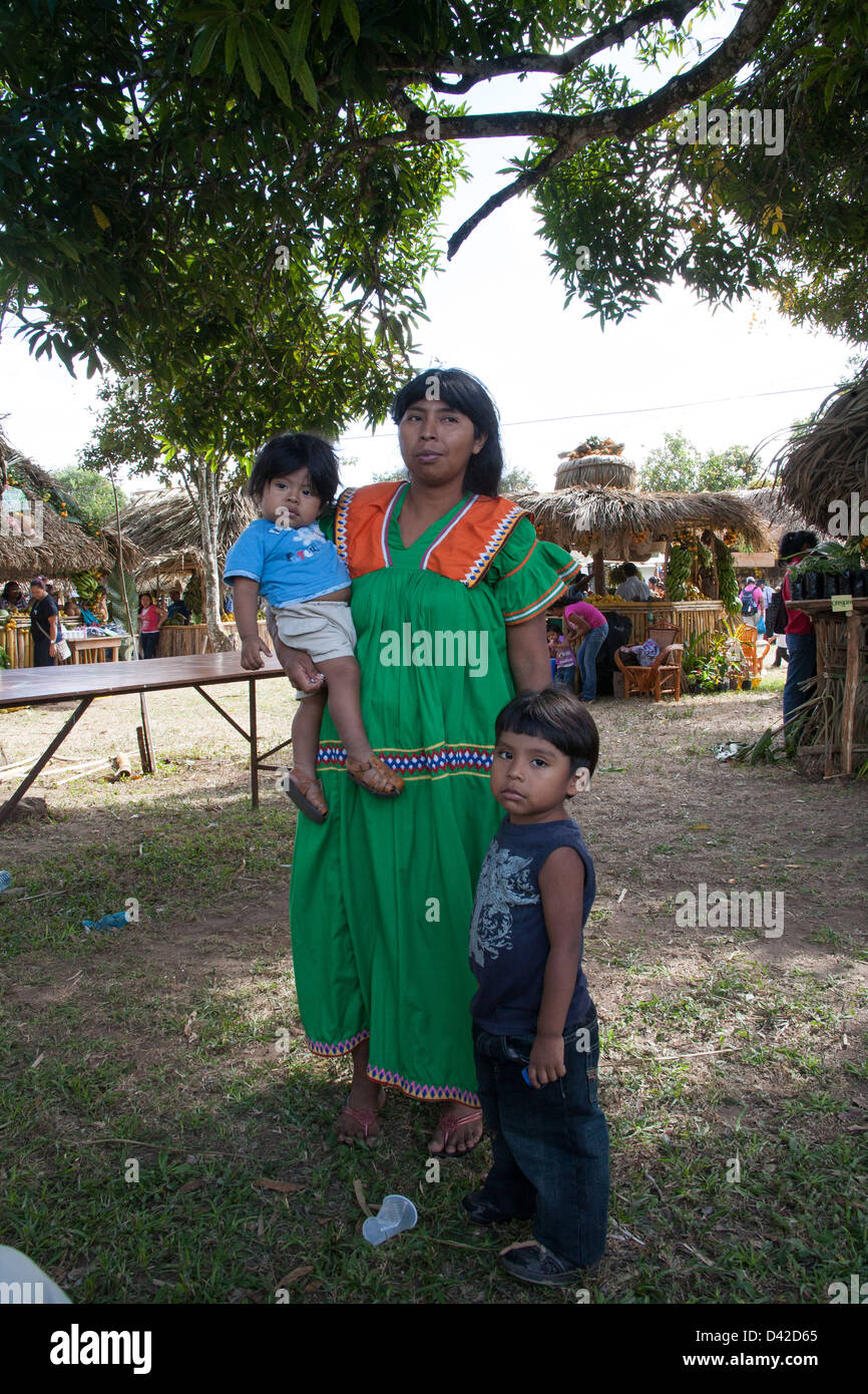 Ngobe - Bugle Comarca tribe woman wearing a traditional outfit with her two children. Stock Photo