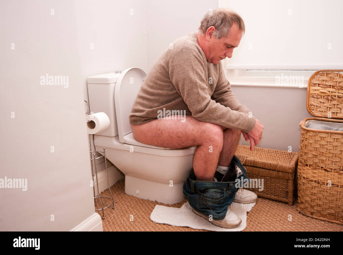 Man sitting on toilet hi-res stock photography and images - Alamy