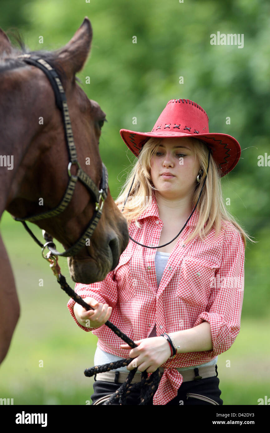 Muehlenbeck, girl with cowboy hat draws on her horse Fuehrstrick Stock Photo