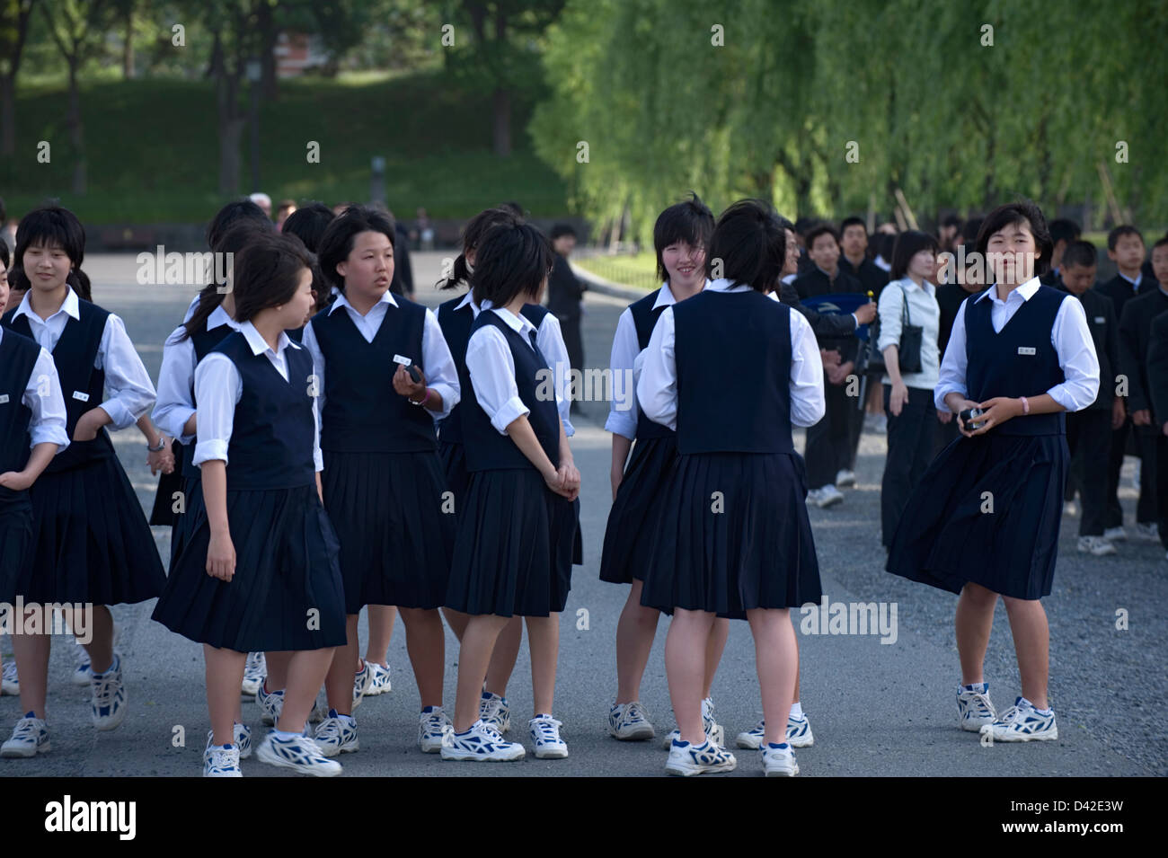 A group of Japanese high school girls in uniform on a field trip to the Imperial Palace in the heart of Tokyo. Stock Photo