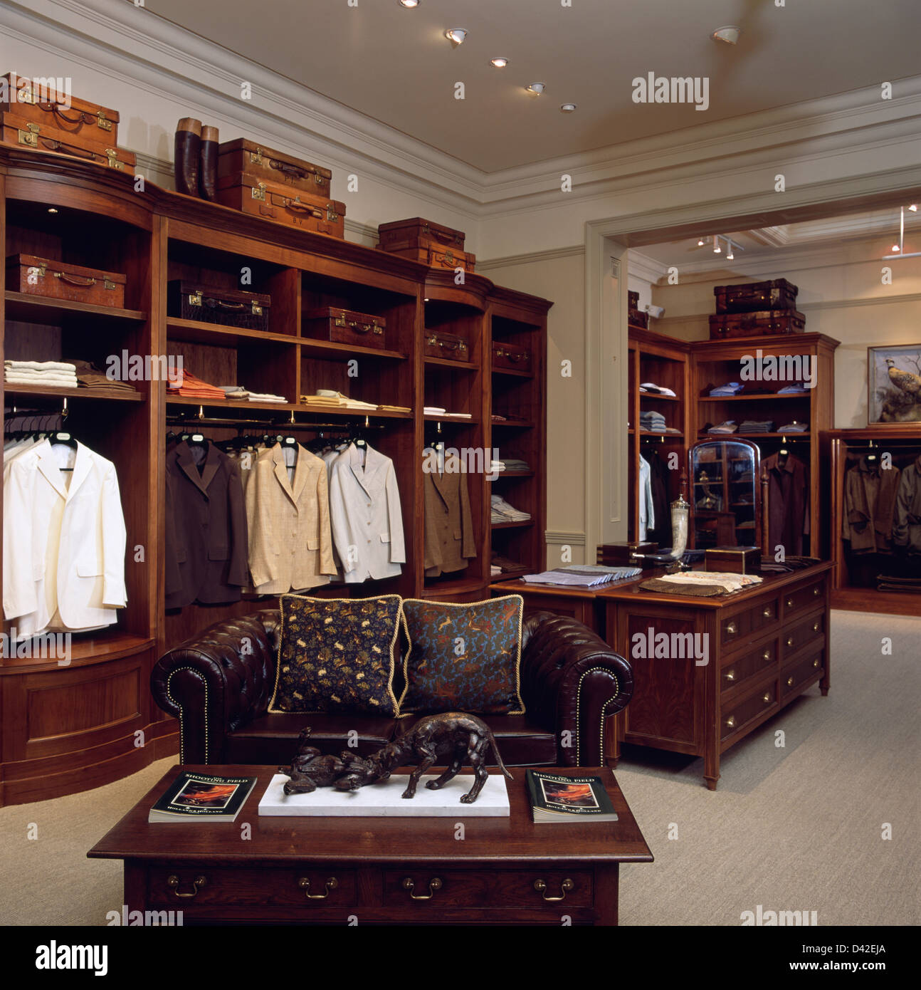 Interior of luxury gentleman's outfitters in London with brown leather  Chesterfield sofa Stock Photo - Alamy