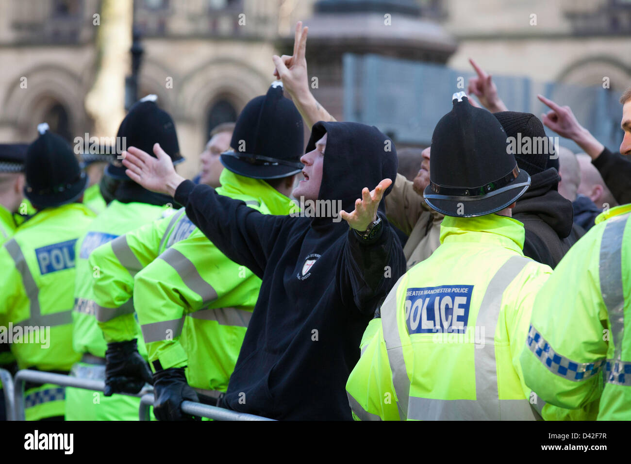 Manchester, UK. 2nd March 2013. Members of the far-right English Defence League (EDL) clash with police during a protest in Manchester. Approximately 300 members of the 'Islamophobic' group attended. EDL members chanting slogans to reporters and people that were gathered at the side of the square overlooking their arrival. Credit: Lydia Pagoni/Alamy Live News Stock Photo