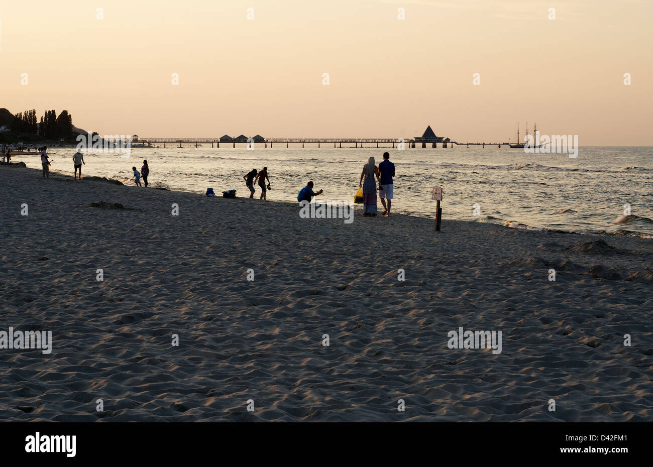 Heringsdorf, Germany, walkers on the beach at Abenddaemmerung Stock Photo